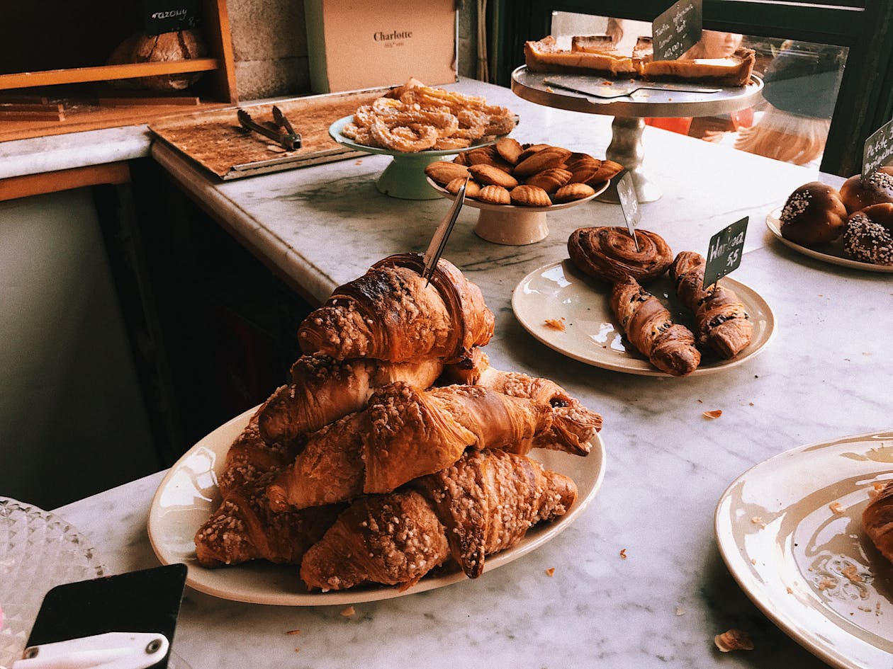 Fresh French croissants and pastries at a Paris bakery counter - French food guide