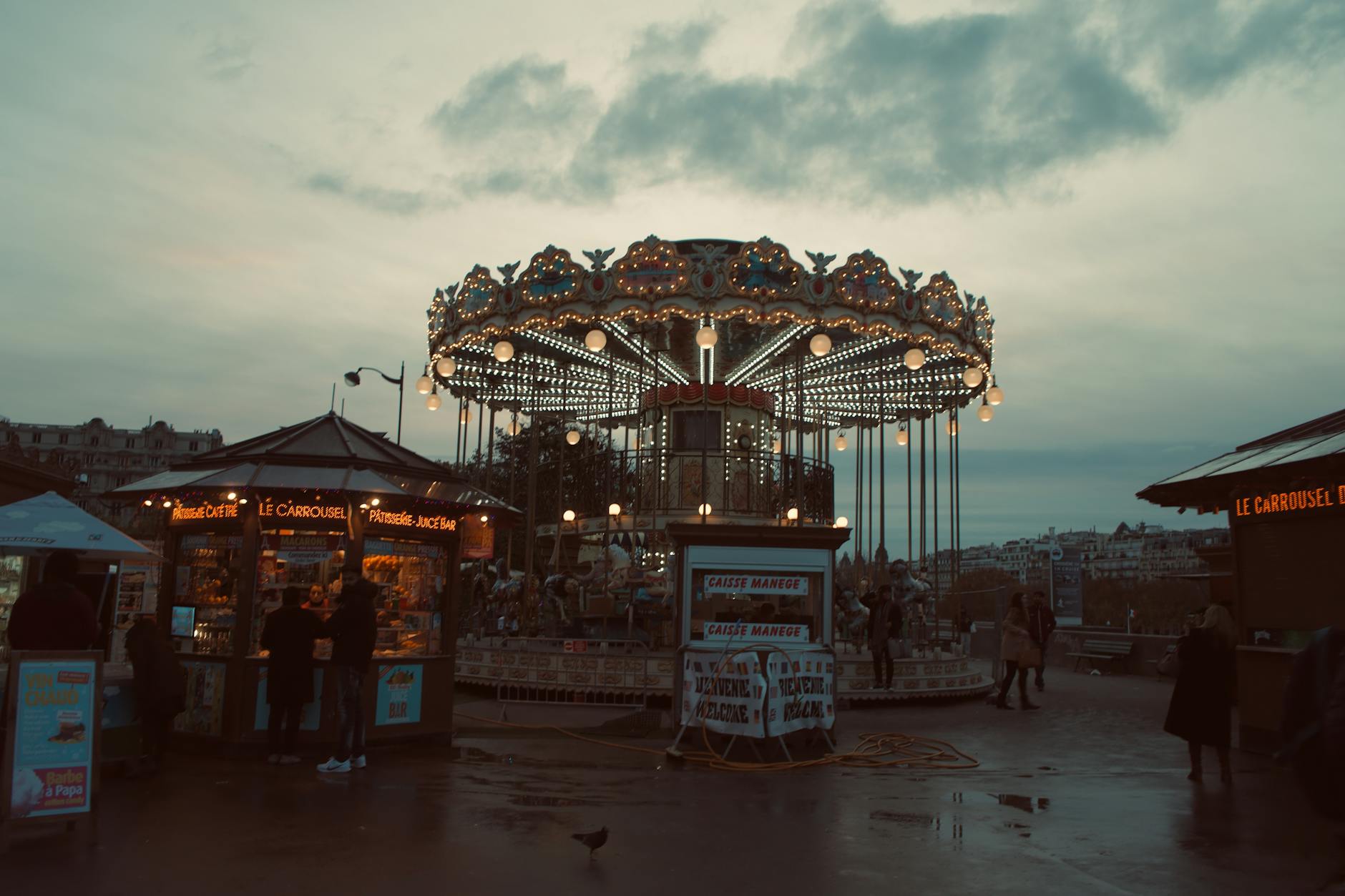 Children riding a classic Parisian carousel near the Eiffel Tower