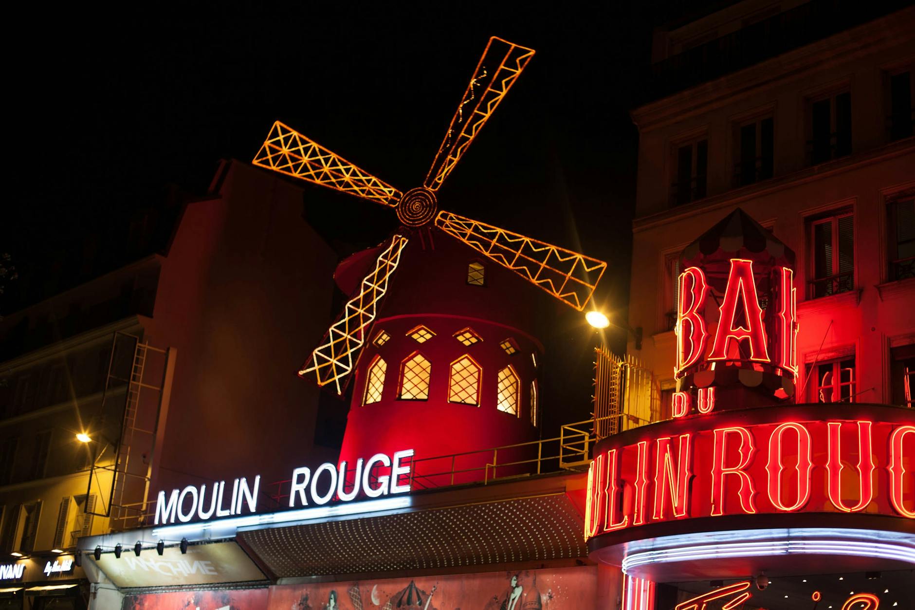 The iconic Moulin Rouge cabaret in Paris illuminated at night