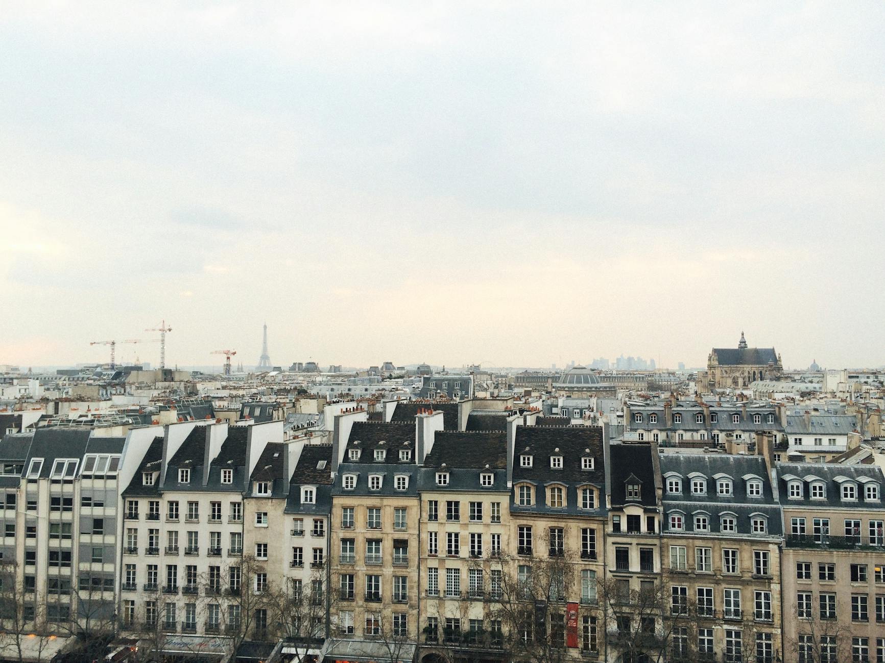 Paris rooftops with the Eiffel Tower rising over the 7th arrondissement neighborhood