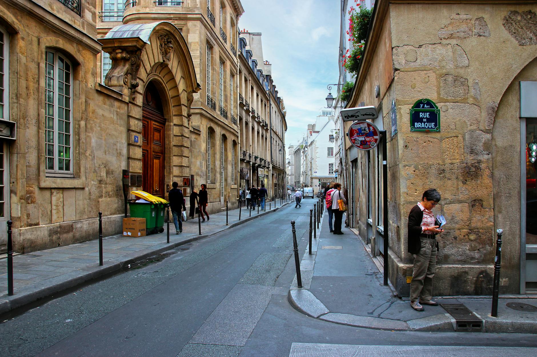 Le Marais neighborhood street in Paris with historic architecture and charming boutiques