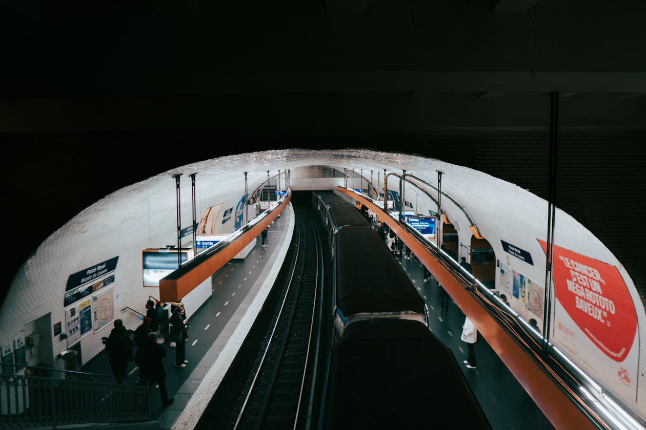 Inside a busy Paris Metro station with commuters - getting around Paris transportation guide