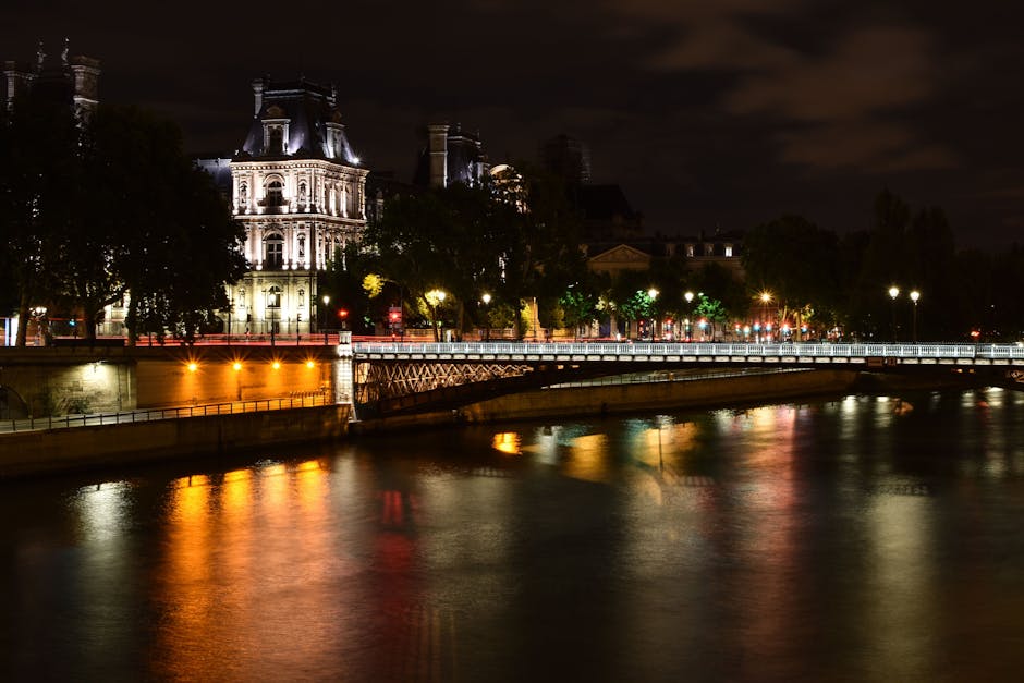 Paris Seine River illuminated at night with historic bridges