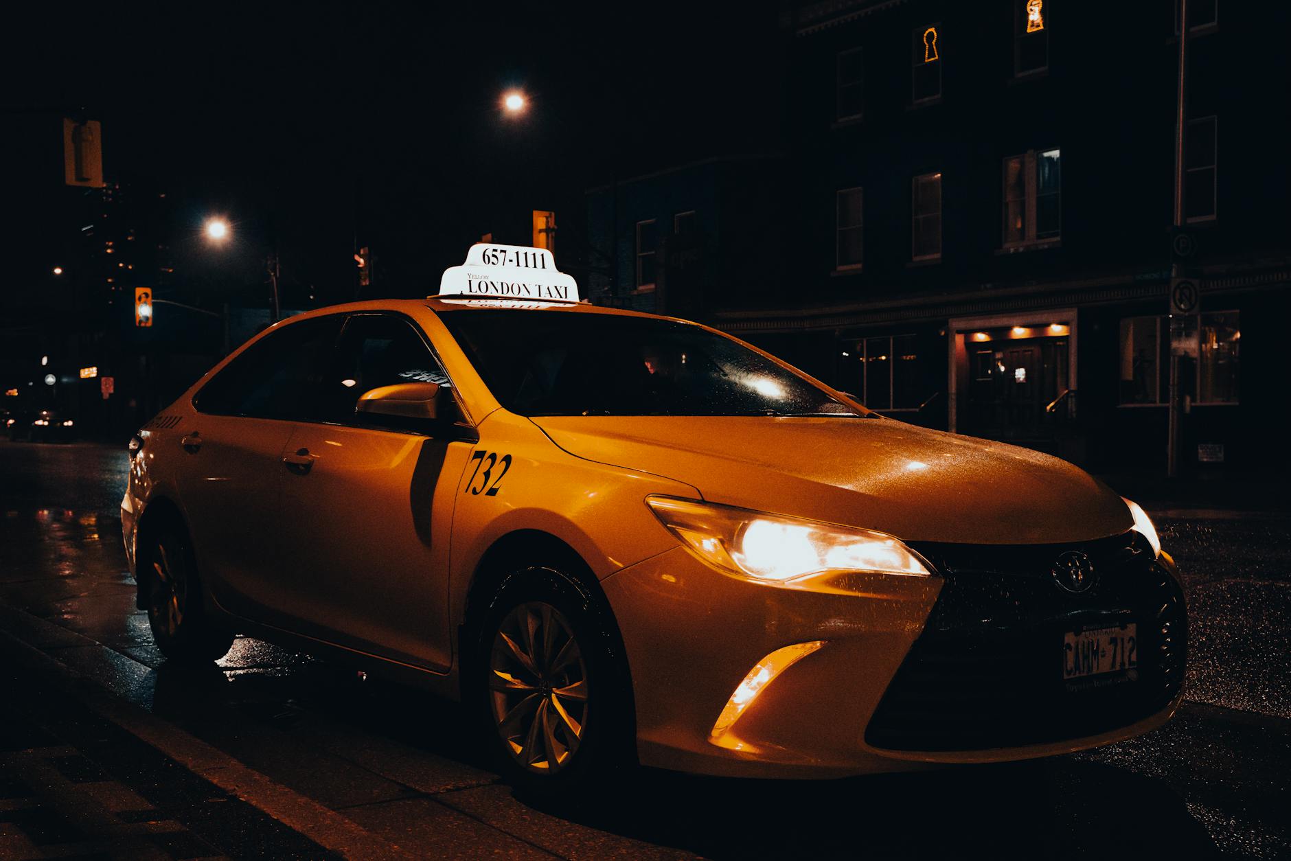 Paris taxi on illuminated city streets at night - a convenient transport option