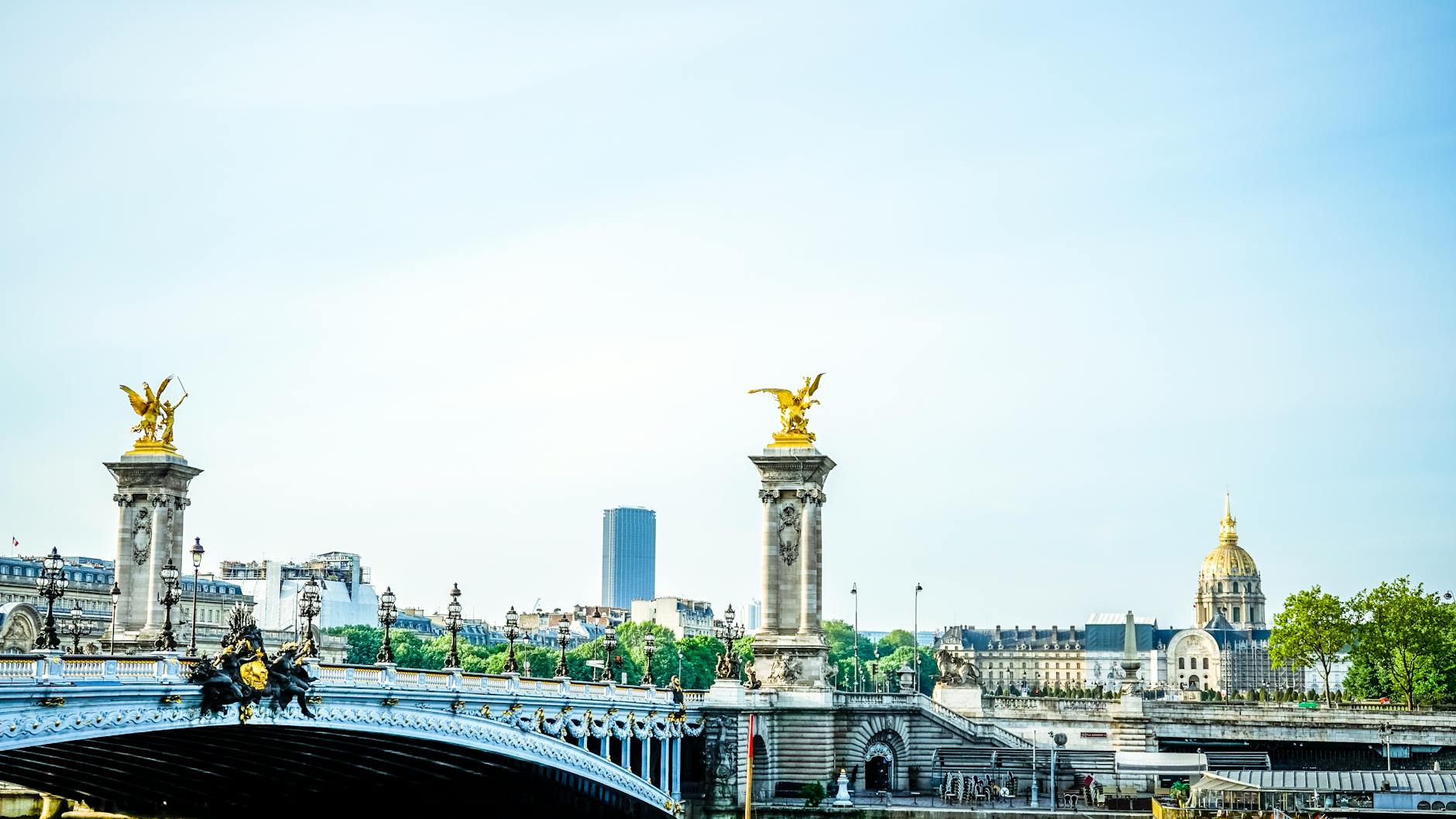 The gilded Pont Alexandre III over the Seine at golden hour in Paris
