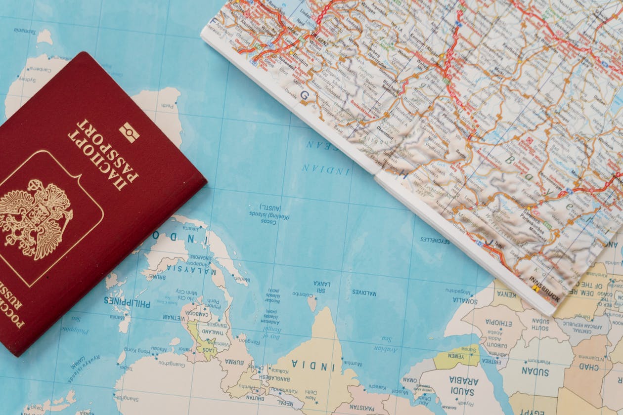 Travel planning essentials with passport and map for planning a trip to Paris
