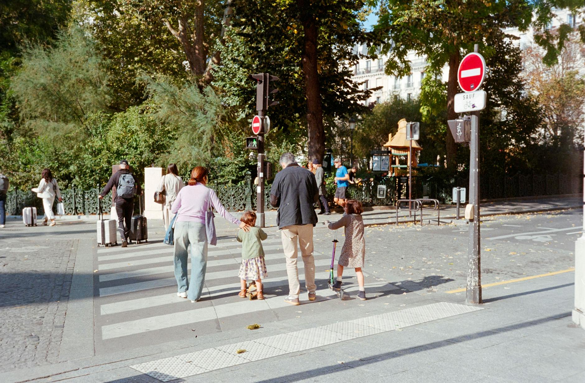 Children playing in a splash fountain at a Paris park in summer