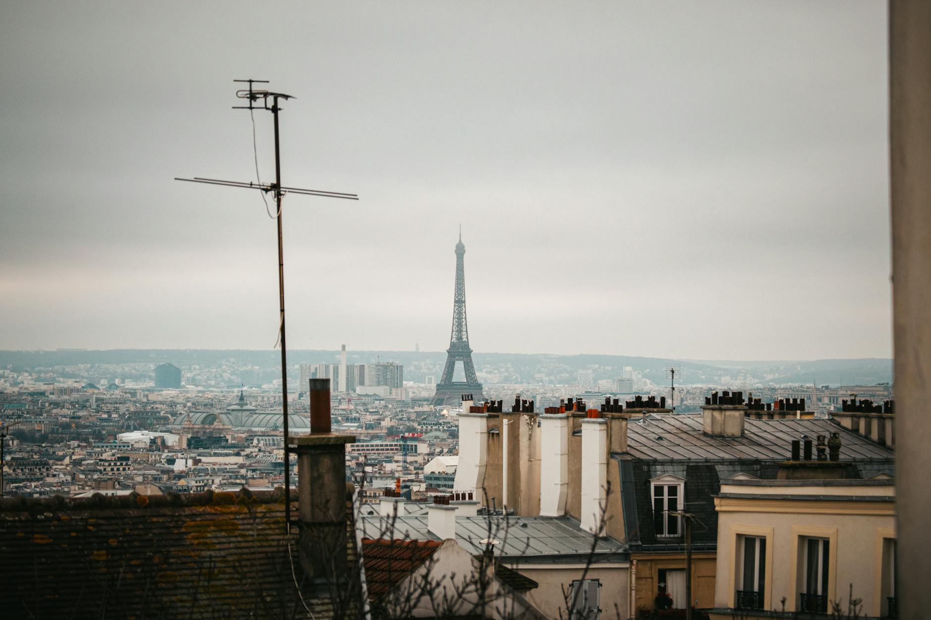 A budget Paris hotel room window showing the Eiffel Tower, the affordable end of hotels with eiffel tower view