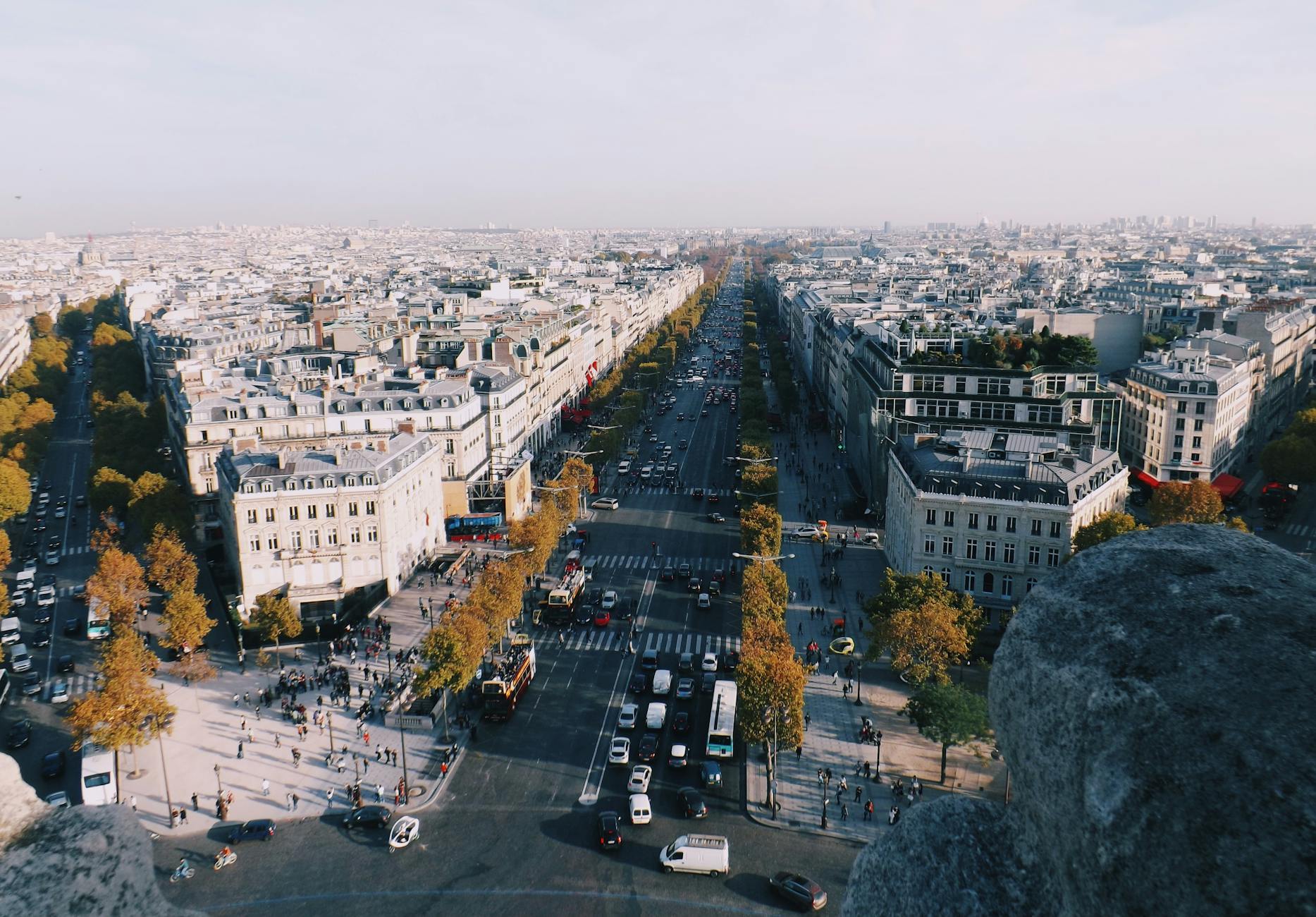 Wide tree-lined Champs-Elysees boulevard with luxury storefronts