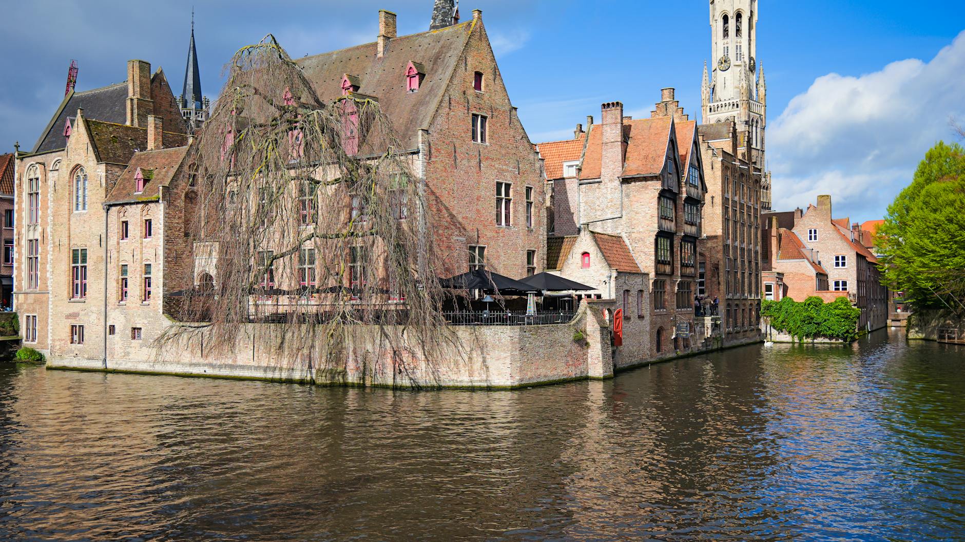 The canals of Bruges glowing at dusk, the reward of an overnight stay