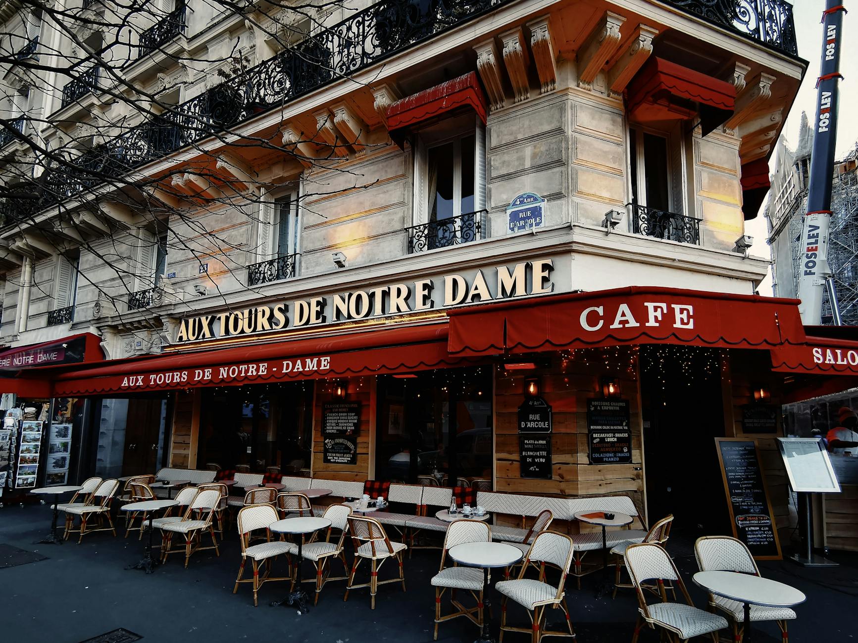 A freelancer working on a laptop at a Marais cafe in Paris