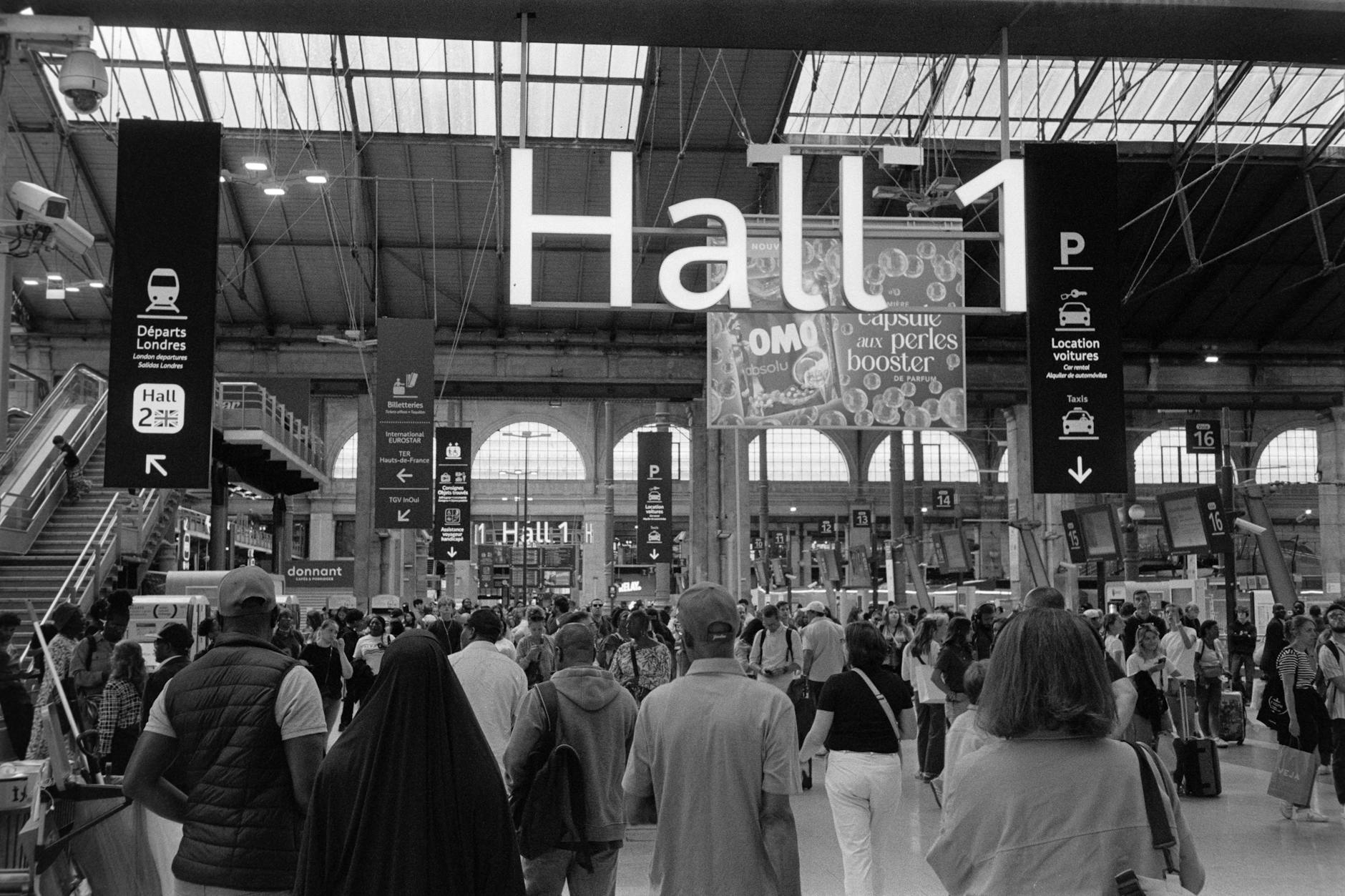 A traveller stepping aboard the Eurostar at Gare du Nord with luggage