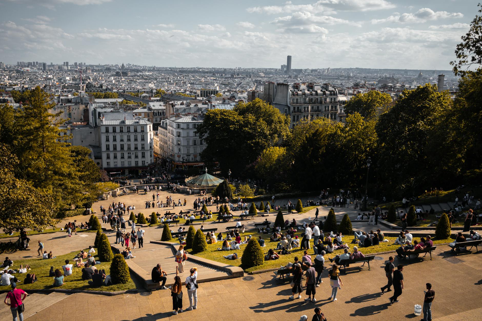 A crowded summer scene in Paris, illustrating the two peak-season windows to avoid