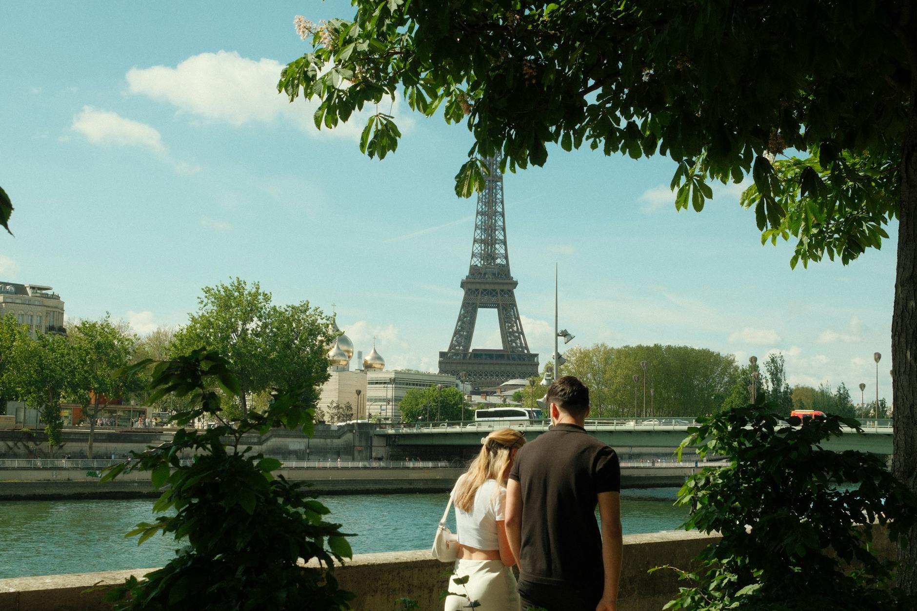 Couple on the Pont des Arts looking toward the Ile de la Cite in Paris