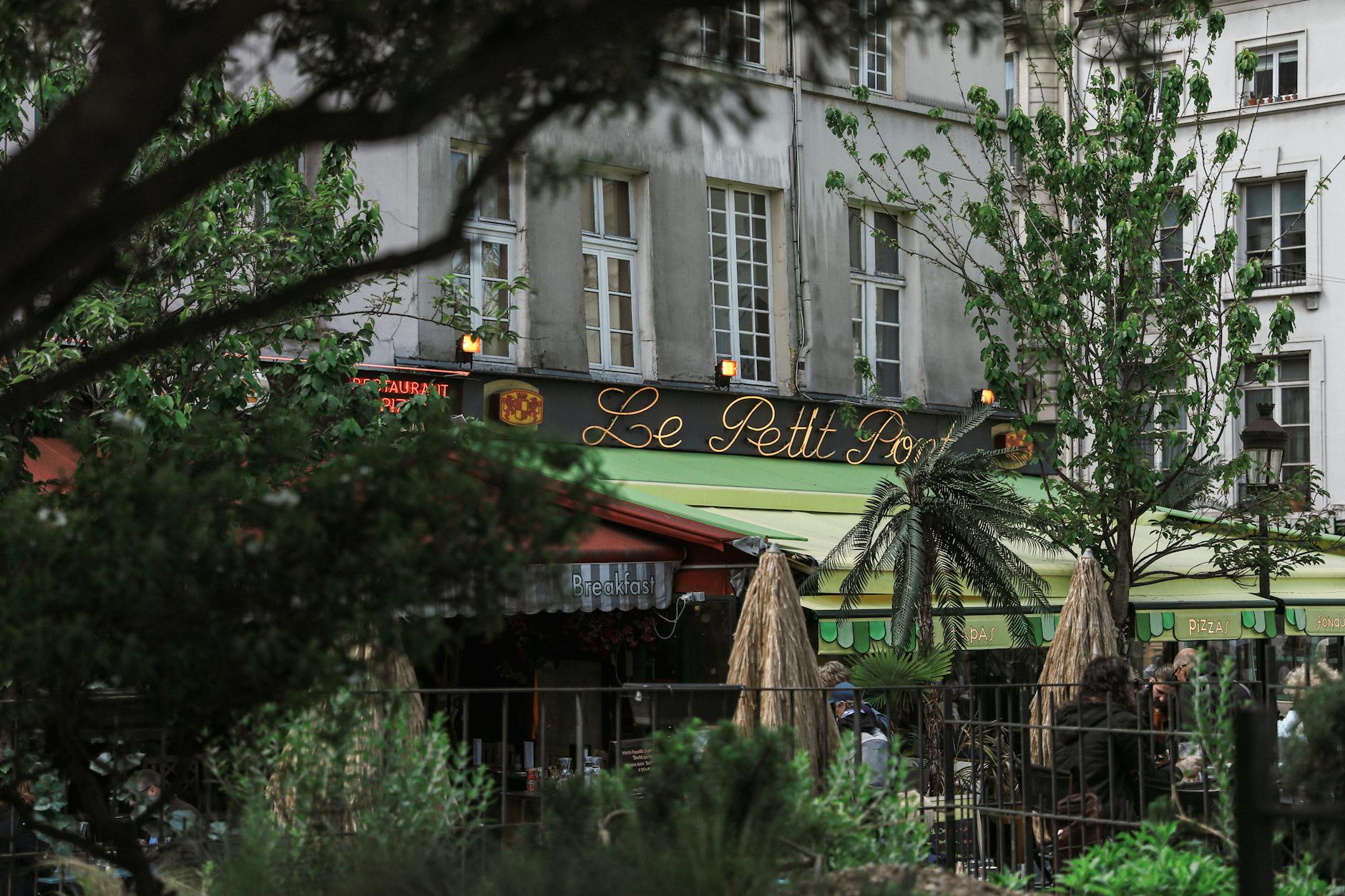 Young drinkers spilling out of a late-night Latin Quarter pub