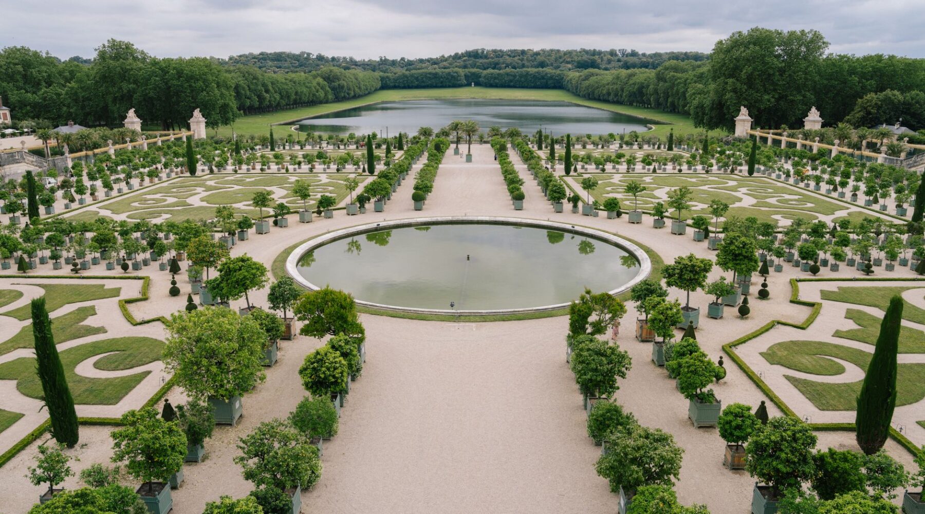 The formal parterres and circular basin of the Versailles gardens looking towards the Grand Canal
