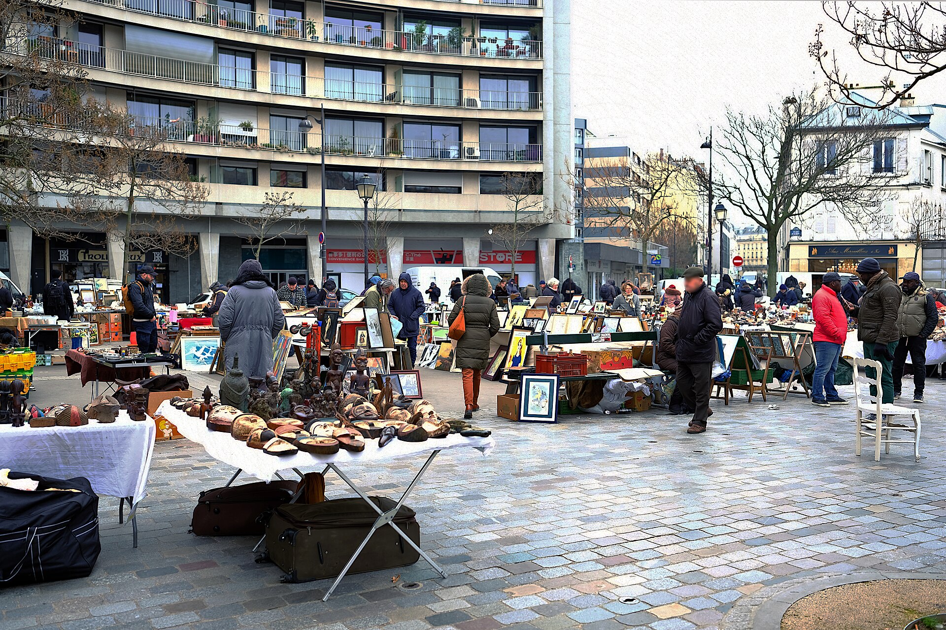 Second-hand stalls of paintings, masks and bric-a-brac at the open-air brocante on Place d'Aligre in eastern Paris